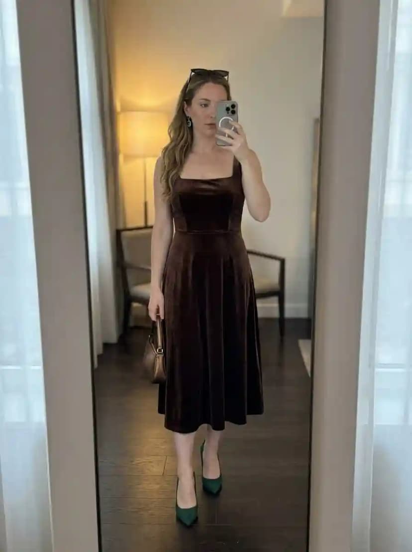 Brown velvet midi dress, emerald green pointed-toe pumps, and gold handbag