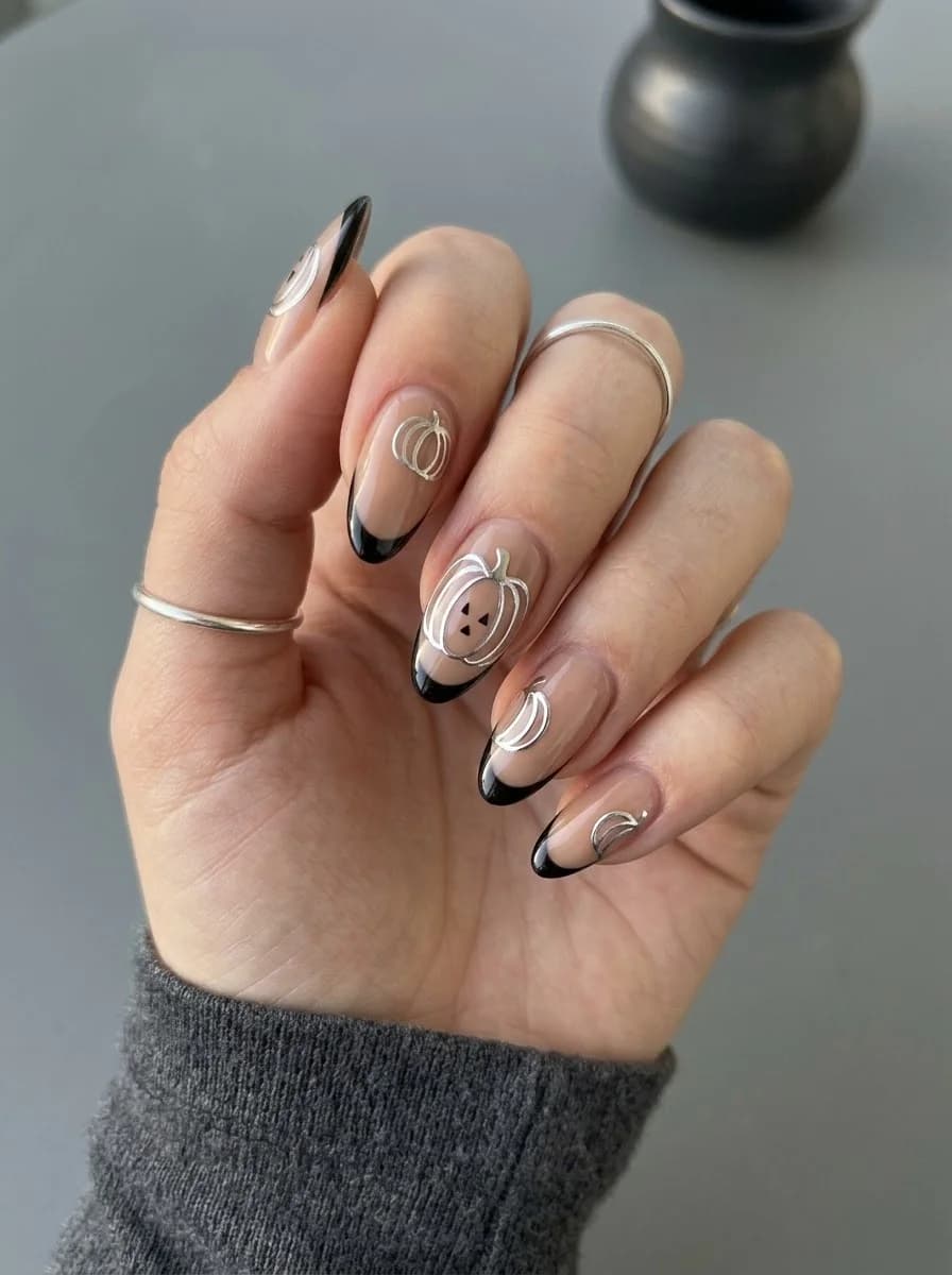 Silver Pumpkin French tip nails with glossy black edges and metallic outlines