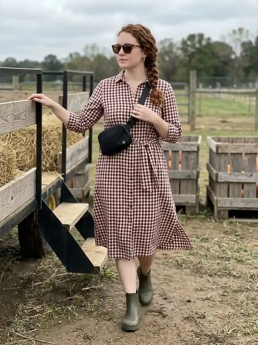 Brown gingham belted shirt dress with olive ankle boots and black crossbody bag