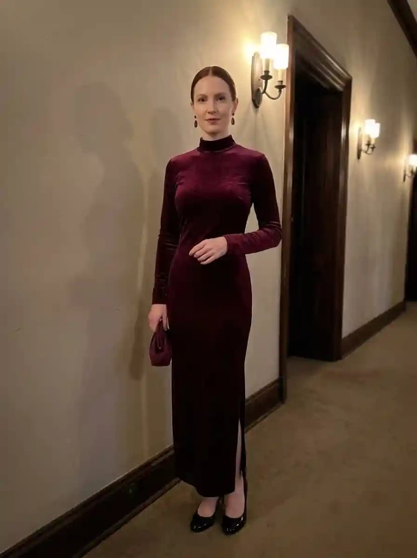 Deep burgundy velvet mock-neck maxi dress with long sleeves and a side slit
