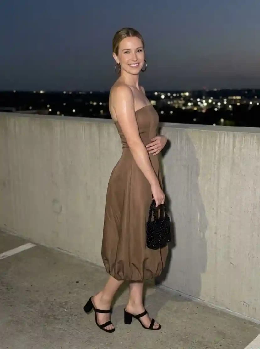 Warm taupe strapless bubble-hem midi dress with black strappy heeled sandals