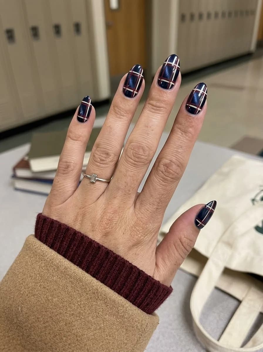 Dark navy nails with a crisp plaid pattern accent