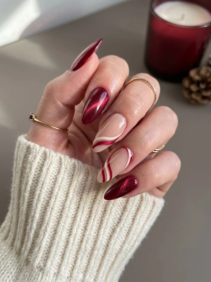 Metallic deep red nails with nude and white stripe accents