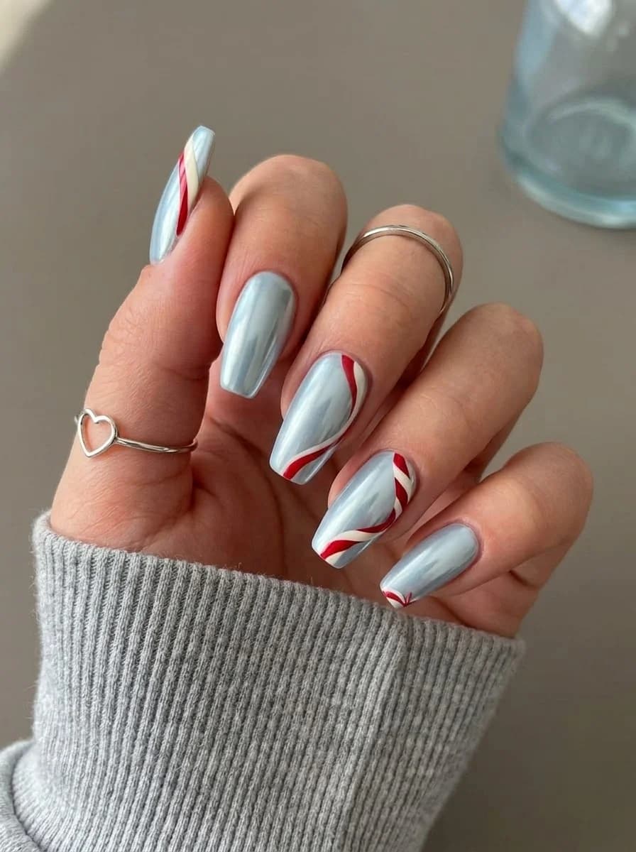 Light blue metallic nails with red and white stripe accents