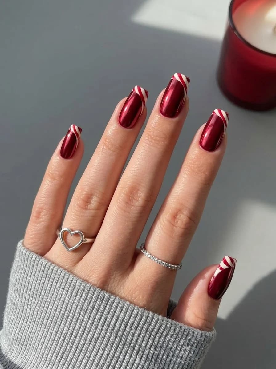 Metallic deep red nails with white stripe accents