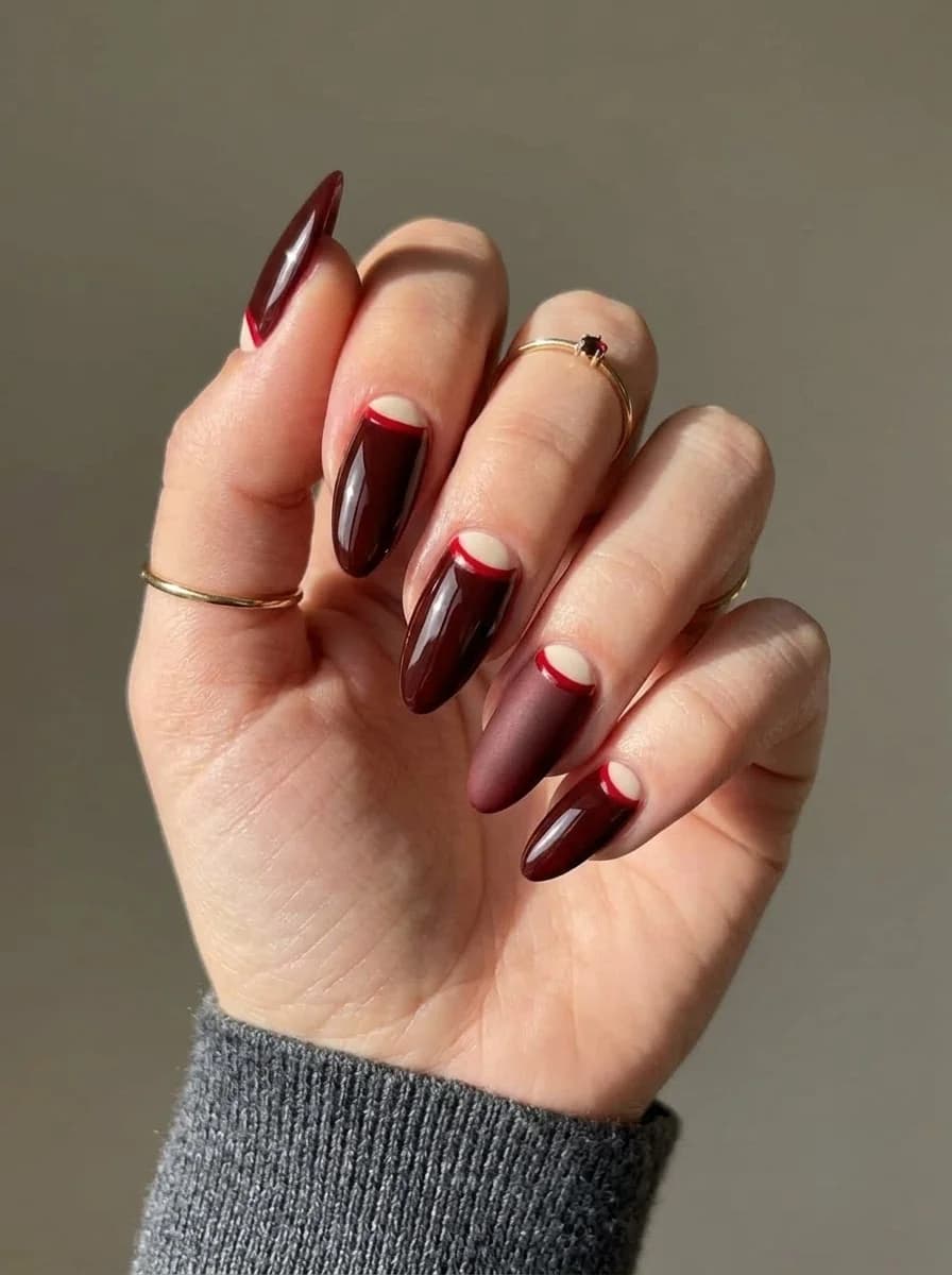 Deep brown nails with nude and red half moon accents