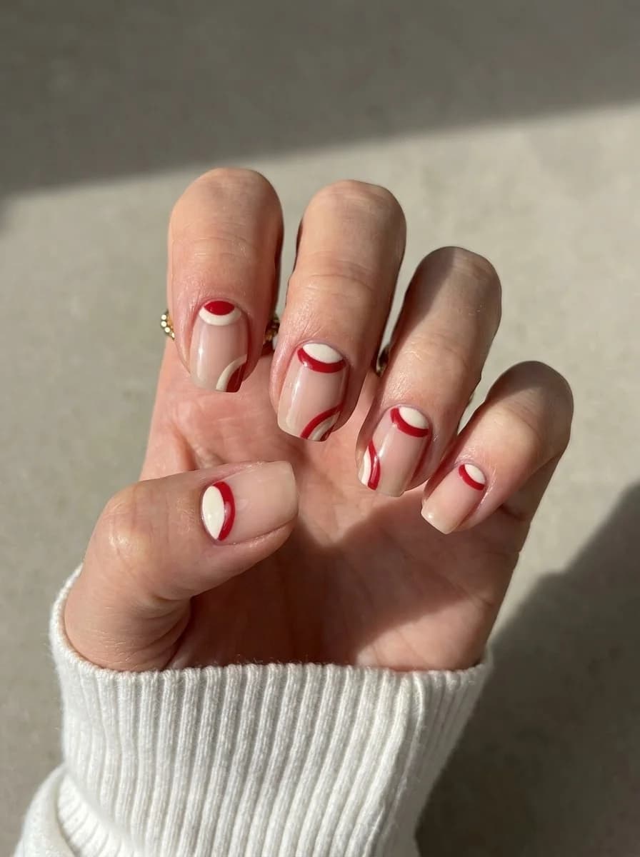 Nude nails with red and white half moon accents