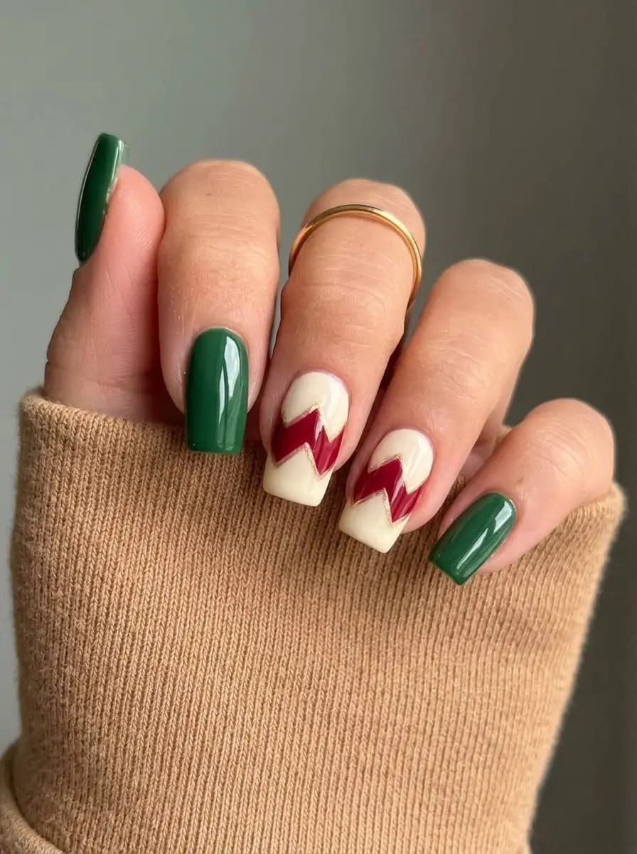 Deep green, cream, and burgundy chevron Christmas nails with gold edging