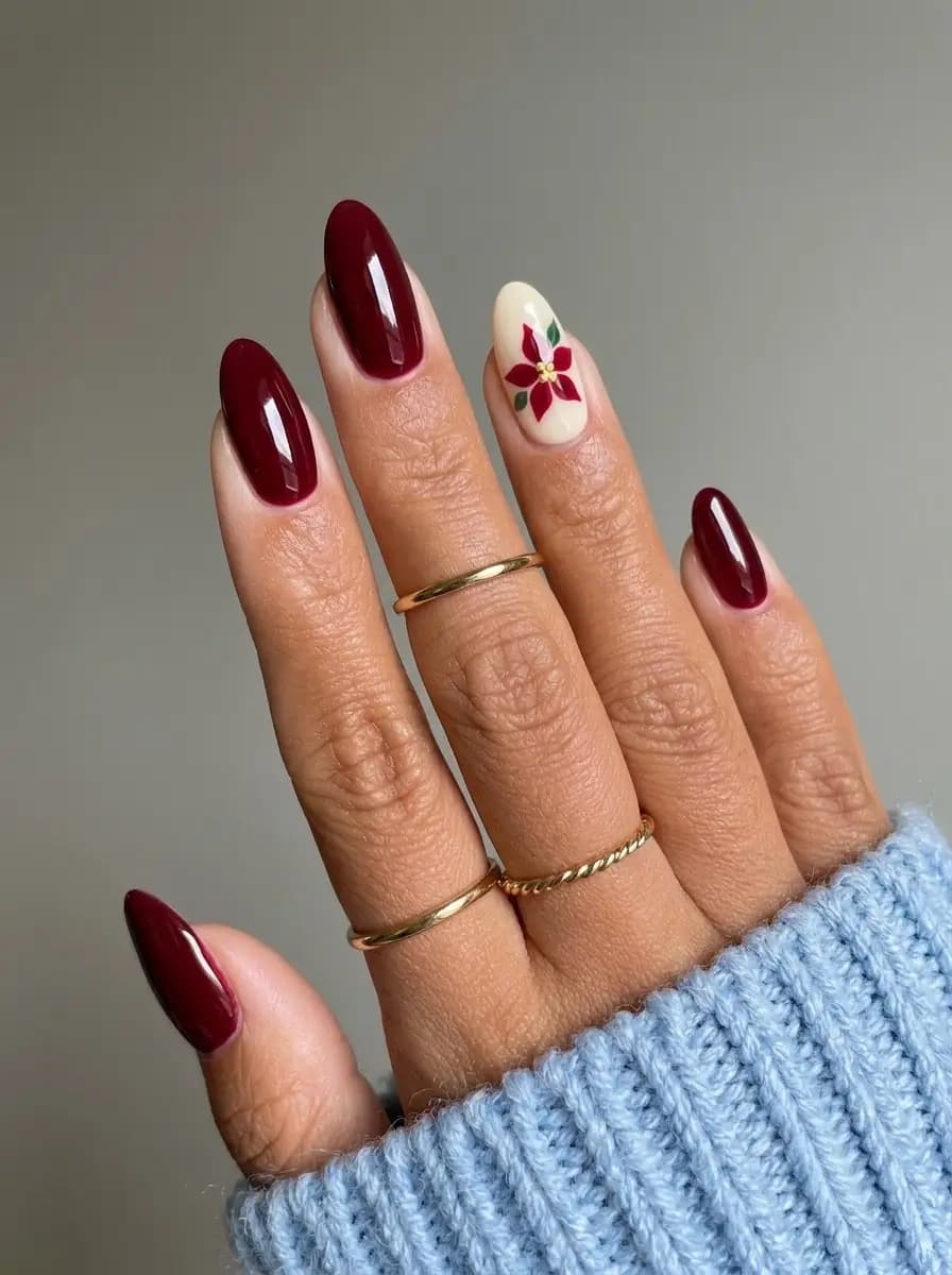 Deep burgundy Christmas nails with hand-painted poinsettia flower accent nail