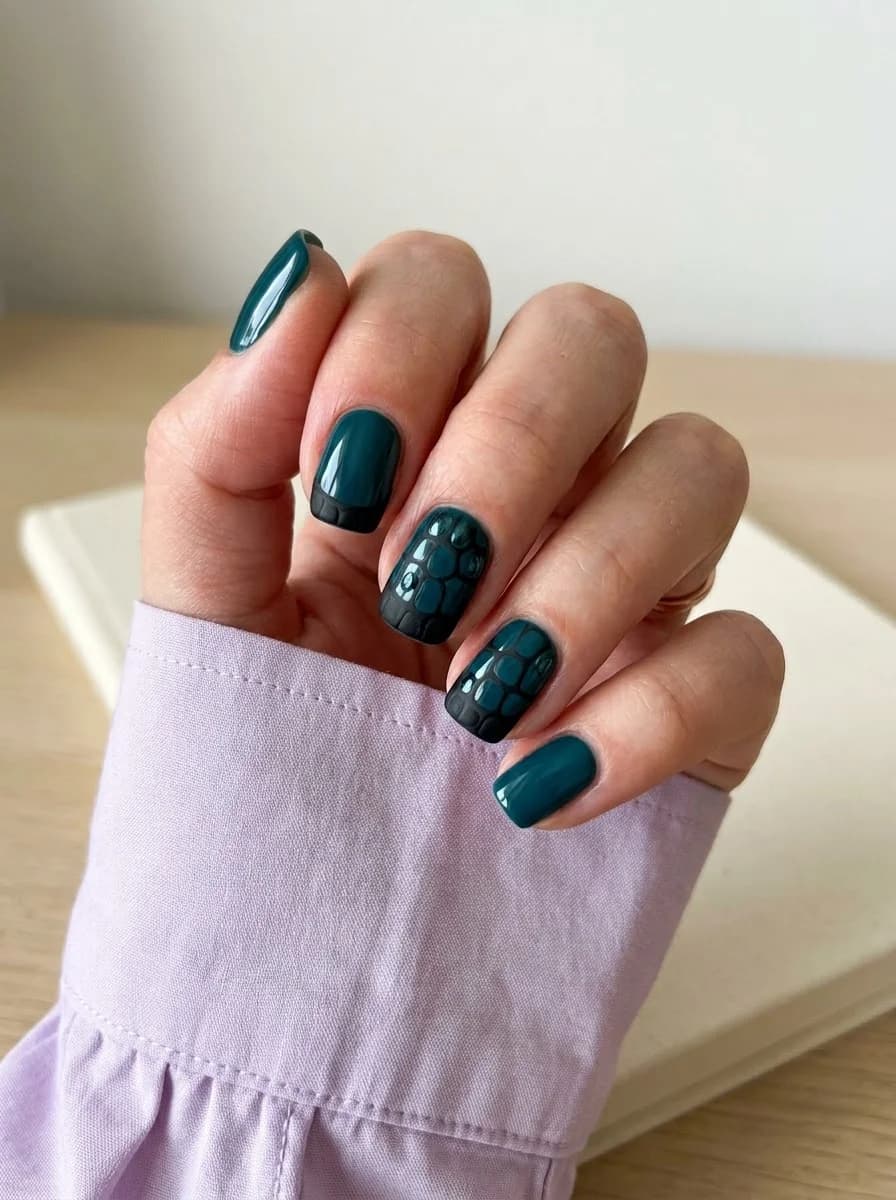 Deep jewel-toned teal nails with raised black crocodile scale texture accents