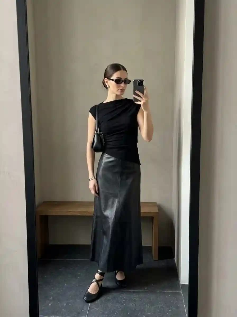 Black cap-sleeve draped top with black leather maxi skirt and strappy black flats
