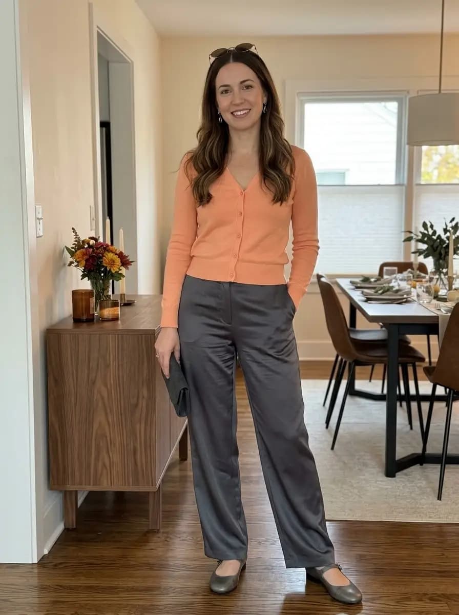 Peach cardigan with charcoal satin wide-leg trousers and grey flats